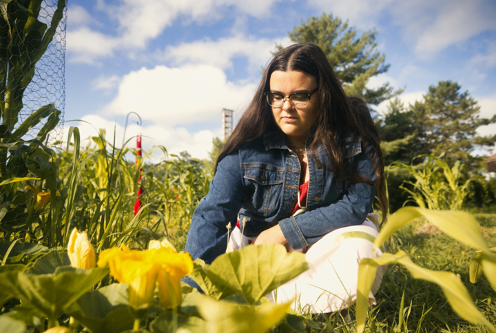 Mikayla Thompson working in the Three Sisters Garden at the Nokomis Cultural Heritage Center in Okemos, Michigan.